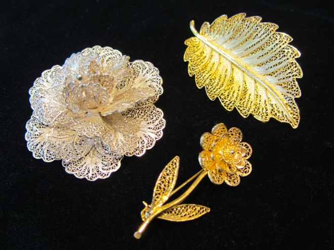 Floral themes are common in filigree jewelry, as are hearts and beads.